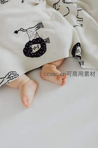 婴儿小脚丫藏在卡通毛毯下