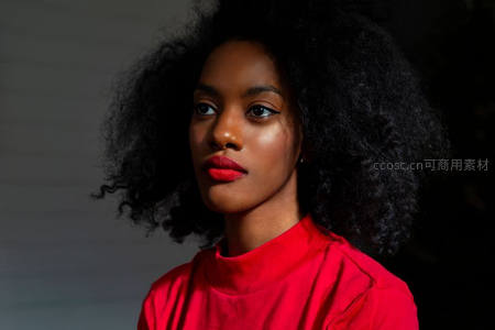 红衣卷发女性凝视镜头