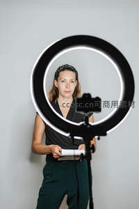 女性主播在环形补光灯前准备直播