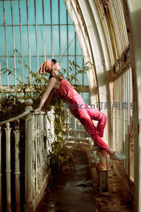 温室长廊中粉衣女子优雅伸展