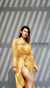光影条纹墙前黄色长裙美人