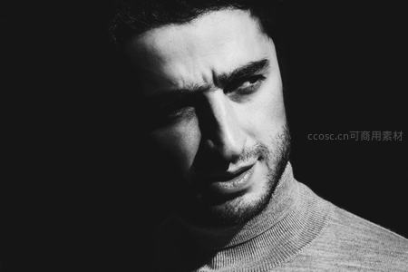 光影交错中男子深邃眼神特写