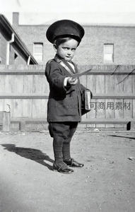 童真男孩穿制服持書本指向前方