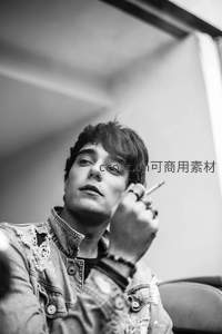 沉思青年手持香烟凝望远方