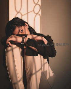 光影中的沉思女子，窗影斑驳如画