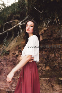 岩壁前白衣女子侧身回眸凝视