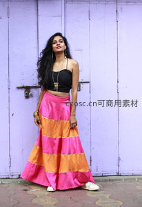 紫墙前的彩色长裙女子