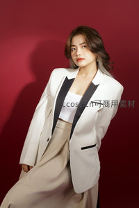 红墙前白西装女凝视镜头