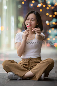 街头少女手持棒棒糖微笑指向镜头