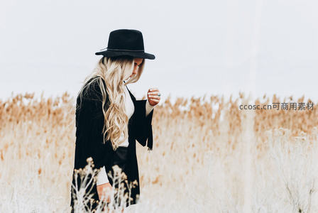 戴帽女子独行枯草田间