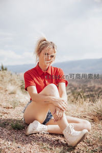 红衣少女山野静坐享受自然风光