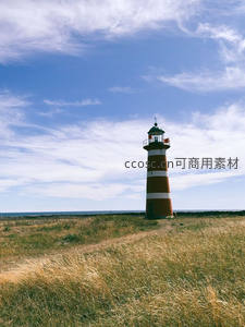 草原上的条纹灯塔，蓝天白云下静谧伫立