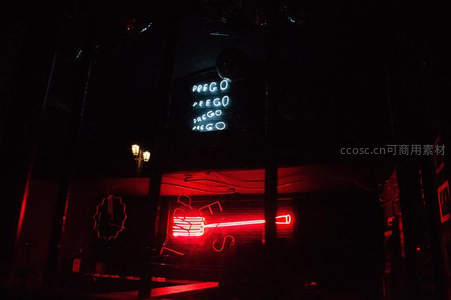 夜店外墙上闪烁的红色与蓝色霓虹招牌