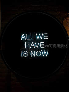 圆形蓝色霓虹灯牌悬挂于砖墙之上