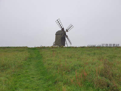 雾中古风车，孤独伫立在青翠山丘之巅