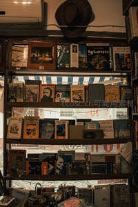 复古书店橱窗陈列各式旧书与帽子