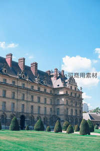 蓝天下的古典宫殿与修剪绿植