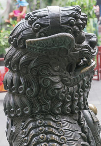 青铜石狮特写，鬃毛卷曲威严守护门户