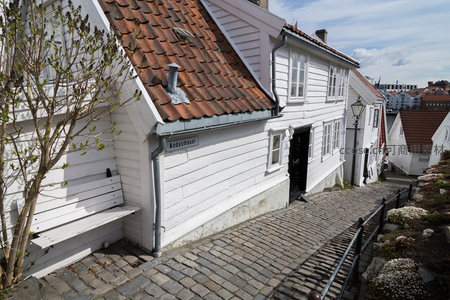 坡道上的白色木屋群，红瓦屋顶与街牌相映