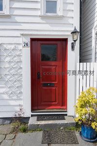 鲜红单门与白色格栅墙构成的温馨住宅门面