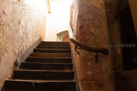 斑驳墙壁与木质扶手的废弃楼梯