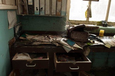 尘封的办公桌，蛛网密布，文件散落一地