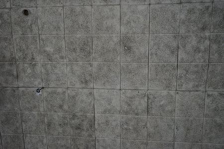 灰色瓷砖墙面的污渍与磨损纹理