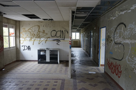 废弃走廊尽头厨房区，天花板塌陷墙满涂鸦