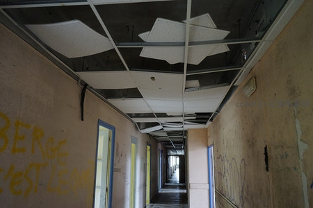 废弃走廊天花板塌陷与涂鸦墙壁