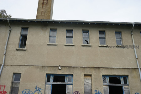 废弃厂房上层，烟囱矗立窗框残缺