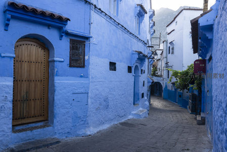 蜿蜒蓝巷中的木质大门，通向神秘的北非人家
