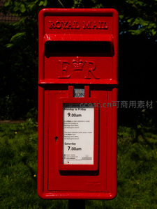 红色皇家邮政信箱矗立在绿茵草地旁