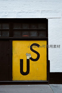 街头涂鸦艺术，黄色门上手绘US字母与手势