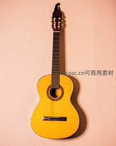 古典吉他悬挂于暖色墙面