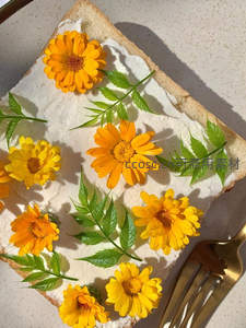 奶油吐司点缀金盏花与绿叶，清新自然的早餐艺术