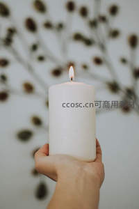 手中点燃的白色蜡烛温暖静谧