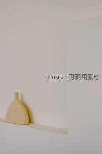 简约米色花瓶静置于纯白墙面凹槽中