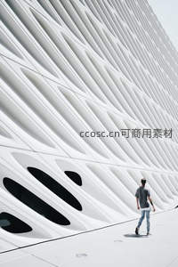 现代建筑前行人走过，几何线条构成视觉冲击