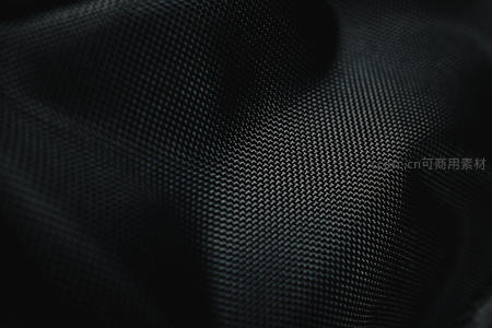 微距镜头下黑色织物表面的细腻网格纹理