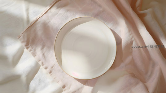 白色瓷盘静置于柔光粉布之上