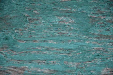 青绿色剥落油漆下的木质纹理特写