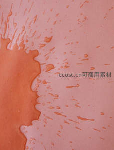 橙色液体在粉色纸面流淌的抽象纹理