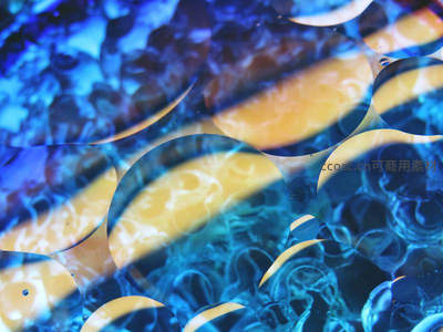 蓝色液体中漂浮的金色油滴微距