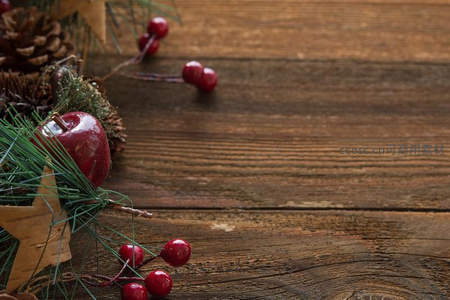 木质背景上的圣诞浆果与松果