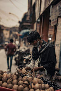 街头小贩整理水果，巷弄人影匆匆