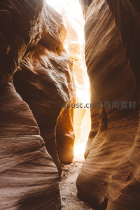 羚羊峡谷光束穿透砂岩裂隙，暖金色光影雕琢流动岩壁