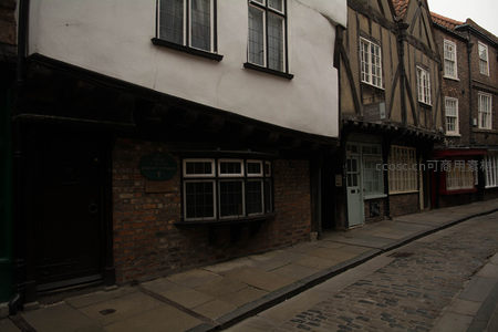 约克老街静谧一角，黑白木构屋檐下砖墙斑驳，绿牌铭刻历史