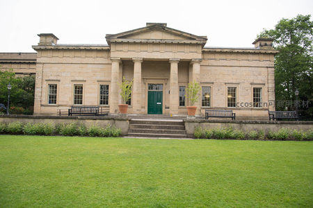 古典石砌建筑前绿茵草坪与陶盆绿植相映成趣