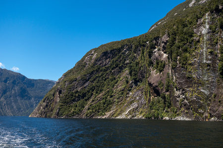 峡湾航程视角：碧水映青山，侧壁瀑布如珠帘垂挂