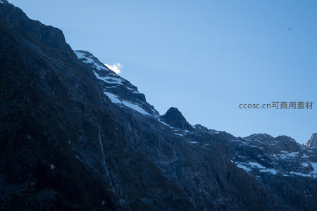 晨光初照雪峰峭壁，云影掠过嶙峋山脊